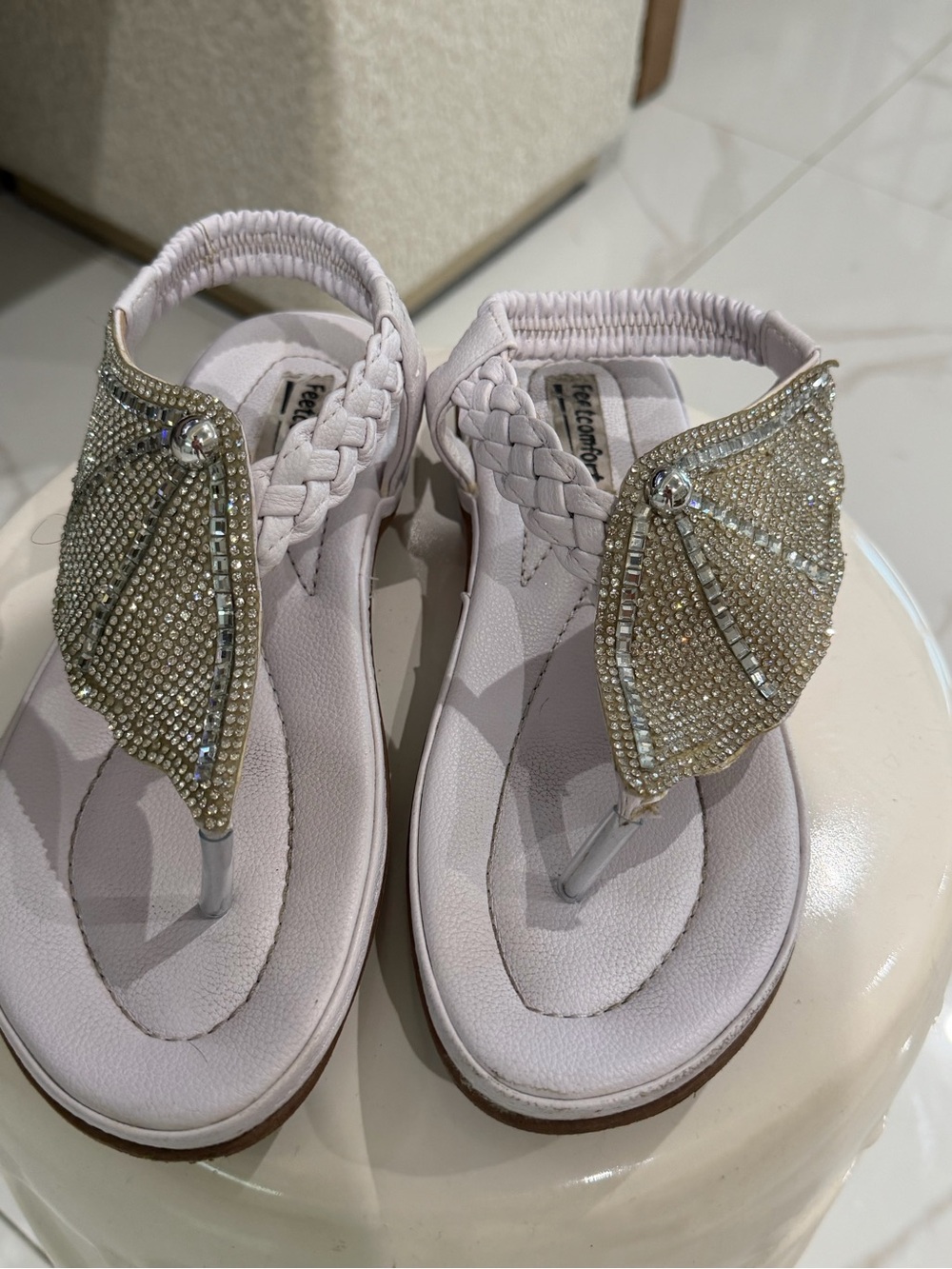 White rhinestone sandals with braided straps.